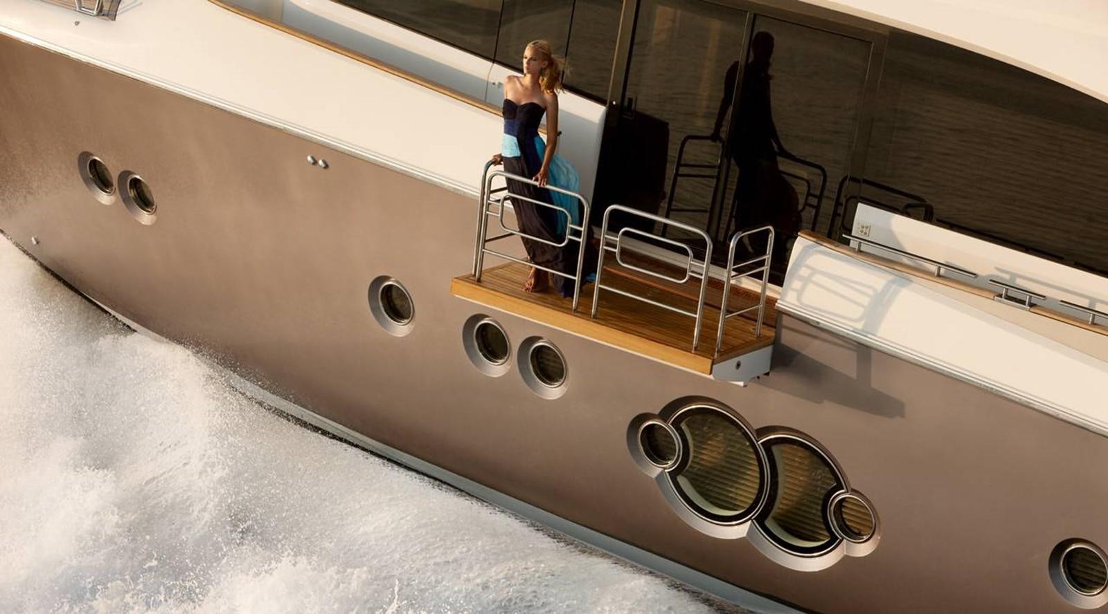 a person sitting on a large white boat aboard MONTE CARLO YACHTS MCY 86 Yacht for Sale