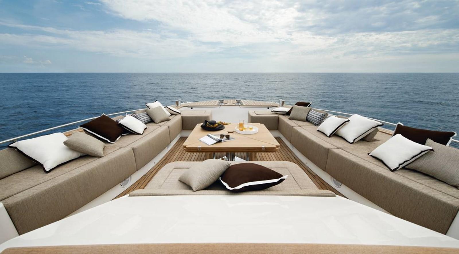 a room with a couch and a table and a large body of water aboard MONTE CARLO YACHTS MCY 86 Yacht for Sale