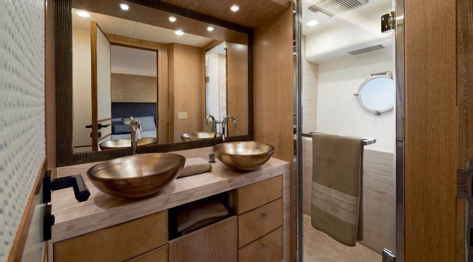 a bathroom with a countertop sink and mirrors aboard MONTE CARLO YACHTS MCY 86 Yacht for Sale