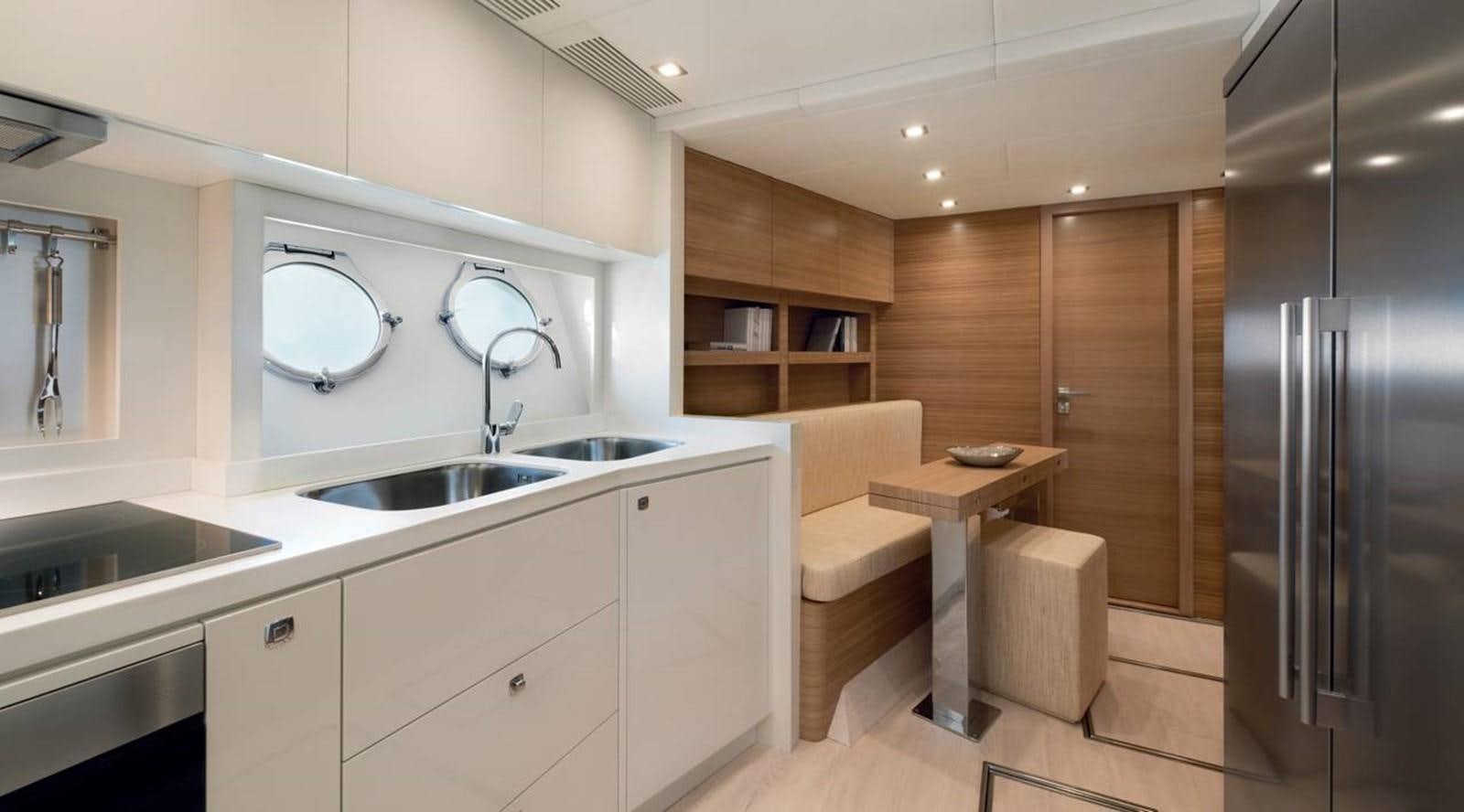 a kitchen with a sink and a refrigerator aboard MONTE CARLO YACHTS MCY 86 Yacht for Sale