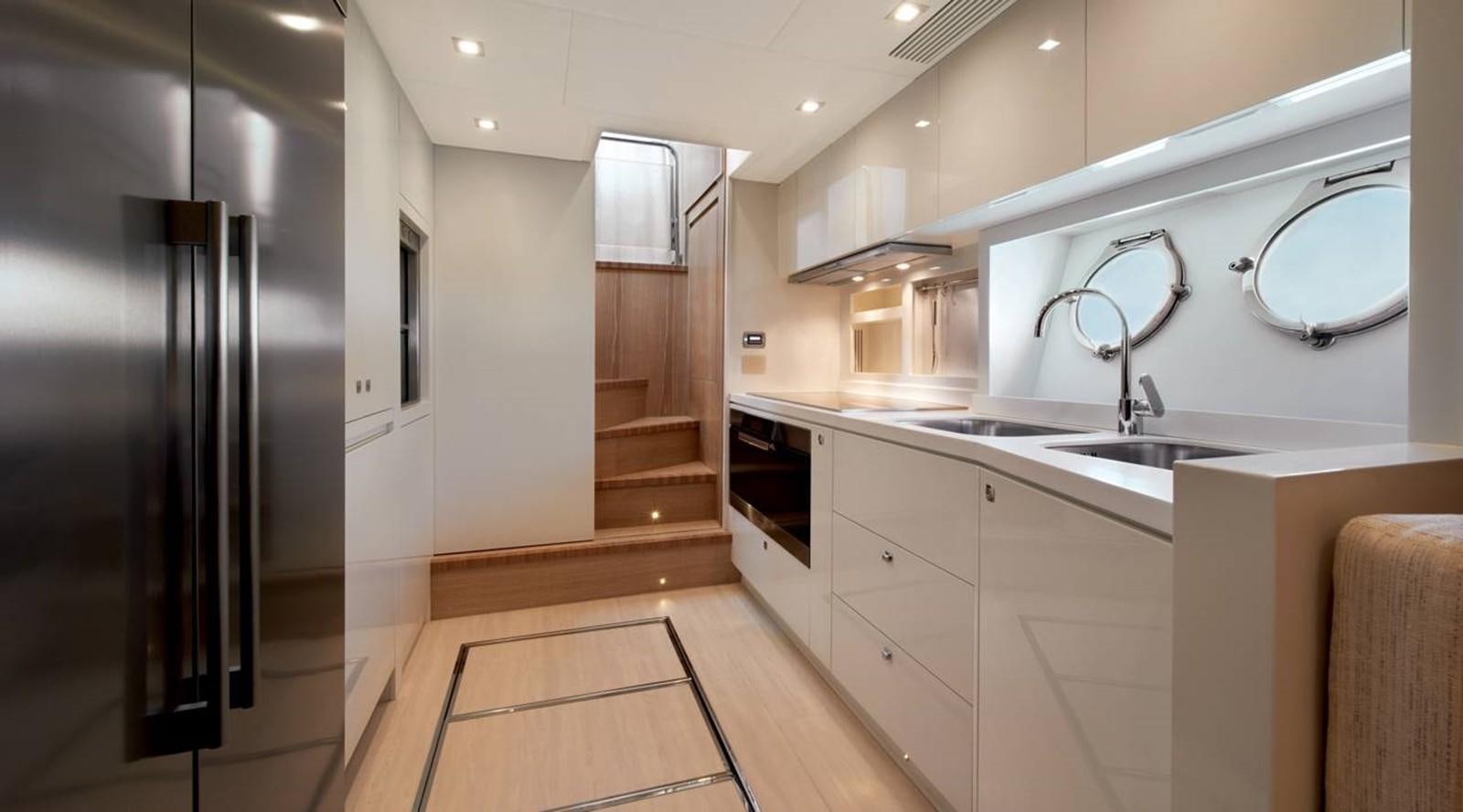 a kitchen with a refrigerator and sink aboard MONTE CARLO YACHTS MCY 86 Yacht for Sale