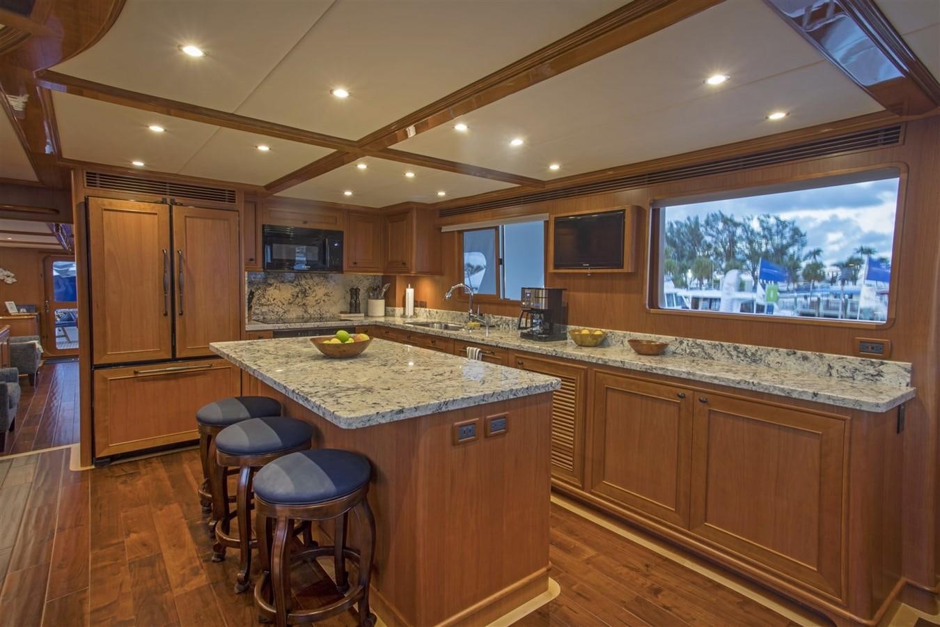 a kitchen with wooden cabinets aboard 860 DBMY Yacht for Sale
