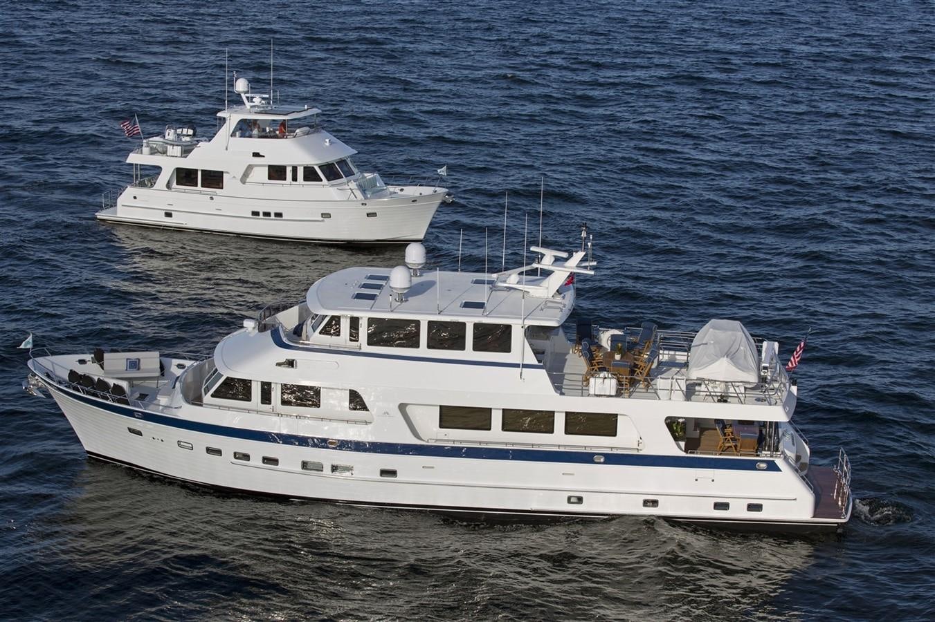 a couple of large white yachts in the water aboard 860 DBMY Yacht for Sale