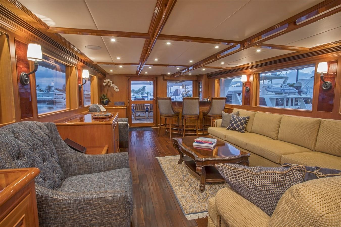 a living room with a wood floor aboard 860 DBMY Yacht for Sale