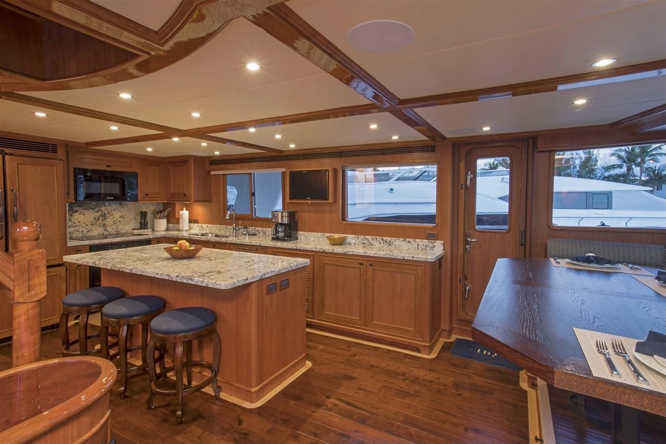 a kitchen with a bar and stools aboard 860 DBMY Yacht for Sale