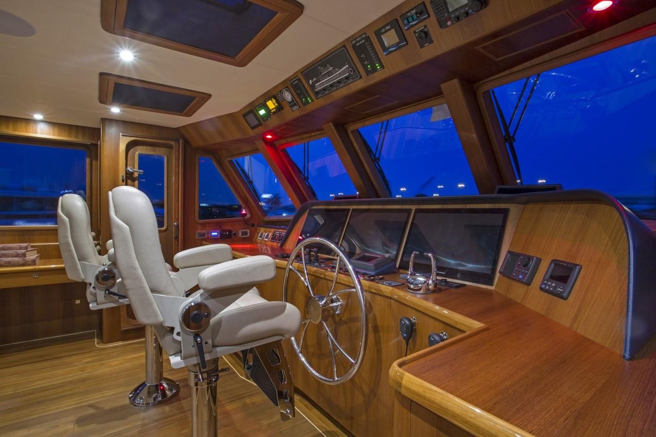 a room with a table chairs and a television aboard 860 DBMY Yacht for Sale
