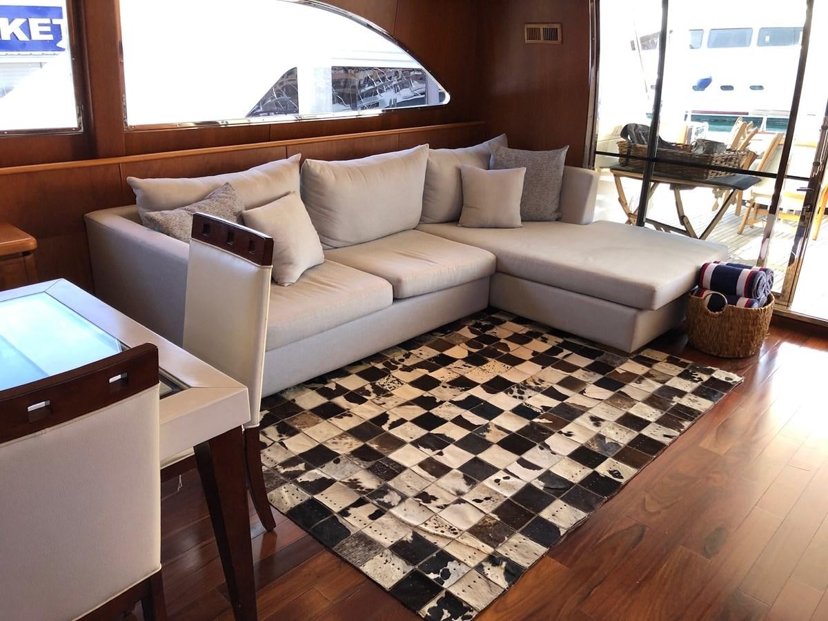 a living room with a couch and a table aboard CATARI Yacht for Sale