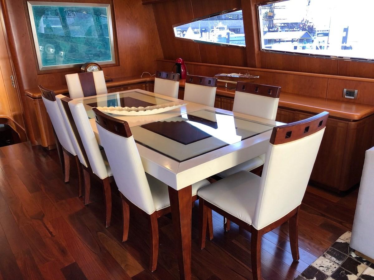 a table with chairs around it aboard CATARI Yacht for Sale