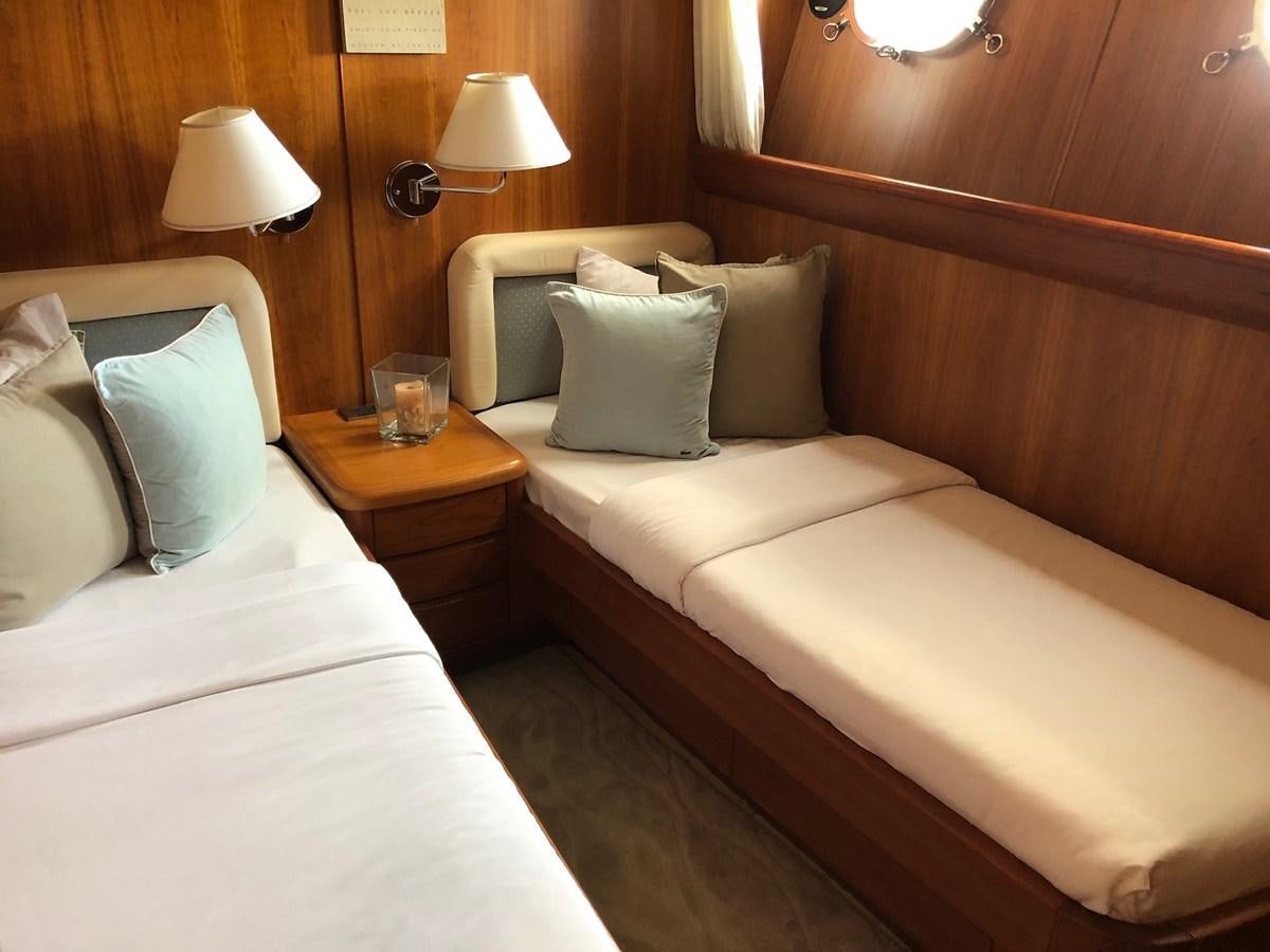 a hotel room with two beds aboard CATARI Yacht for Sale