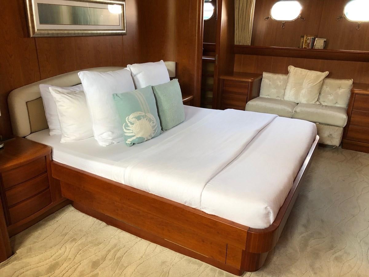 a bed with white sheets and pillows aboard CATARI Yacht for Sale