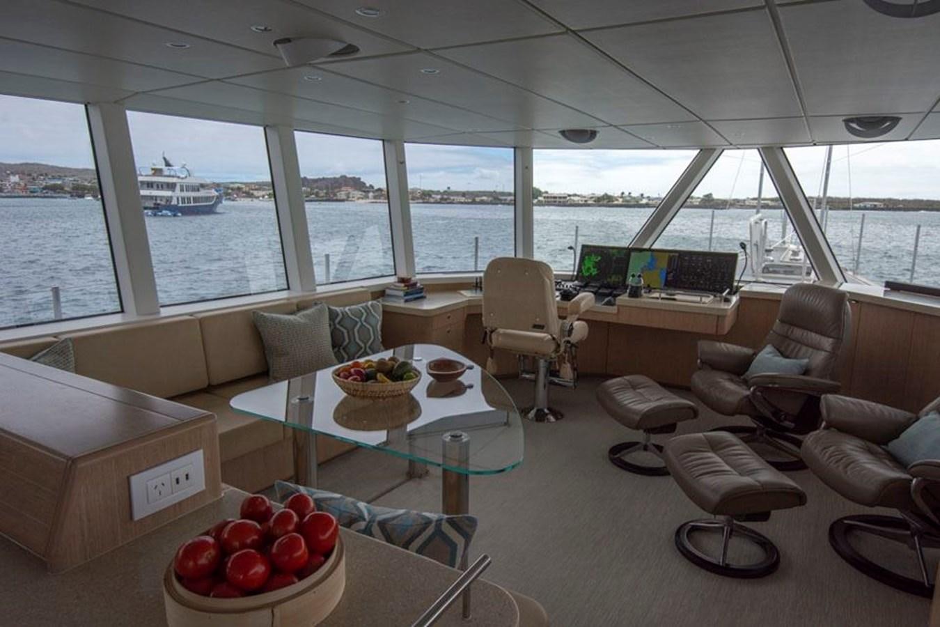 a room with a table and chairs aboard IRON LADY II Yacht for Sale