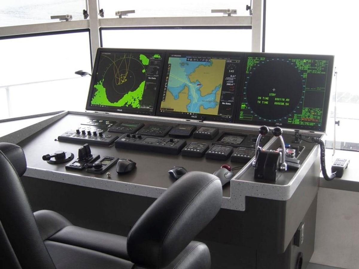 a desk with computers and monitors aboard IRON LADY II Yacht for Sale
