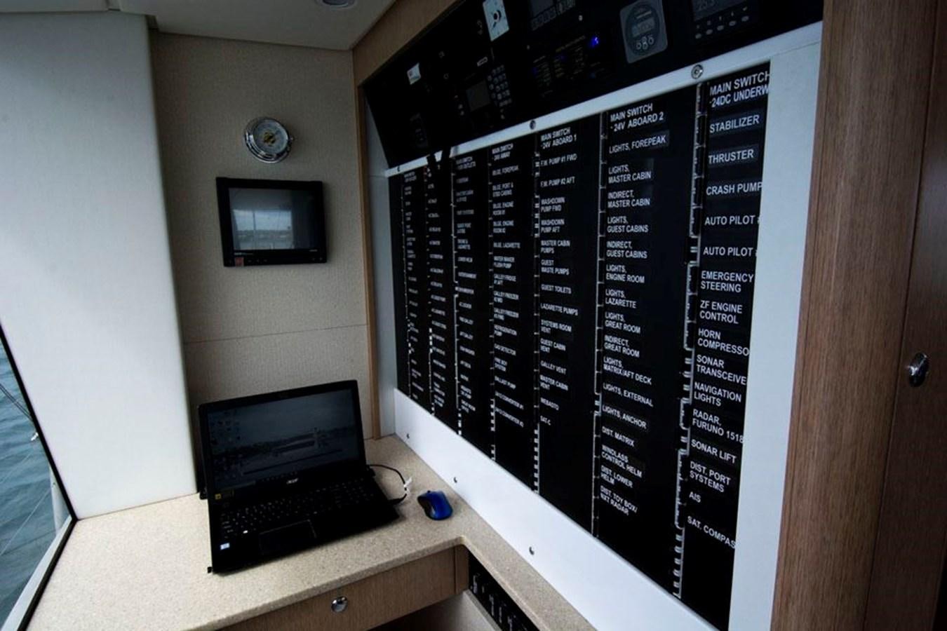 a laptop sits on a desk aboard IRON LADY II Yacht for Sale