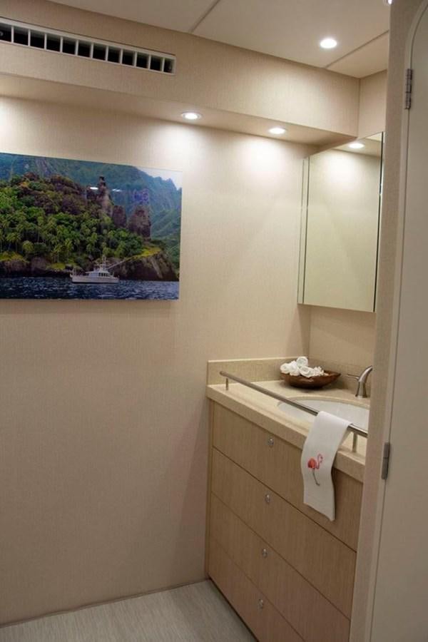 a bathroom with a large picture on the wall aboard IRON LADY II Yacht for Sale