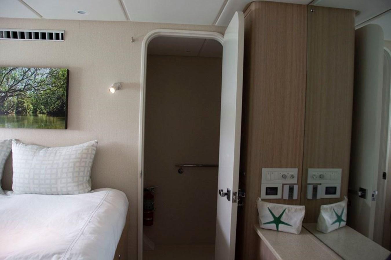 a room with a bed and a door aboard IRON LADY II Yacht for Sale