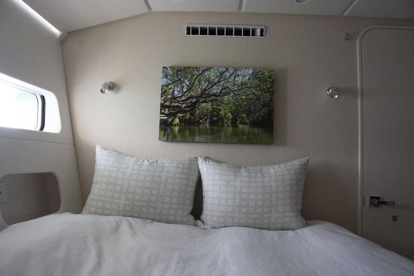 a bed with white sheets and pillows aboard IRON LADY II Yacht for Sale