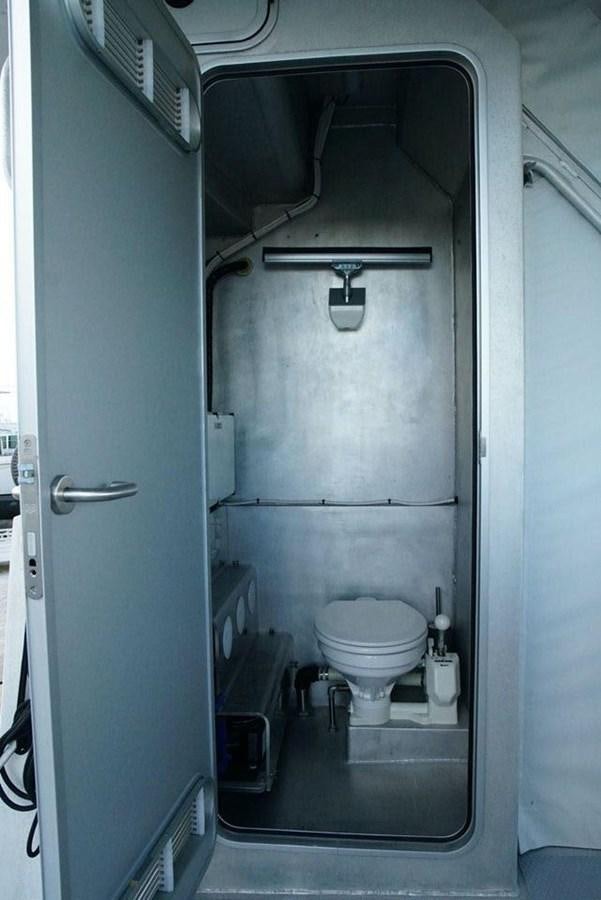 a toilet in a bathroom aboard IRON LADY II Yacht for Sale