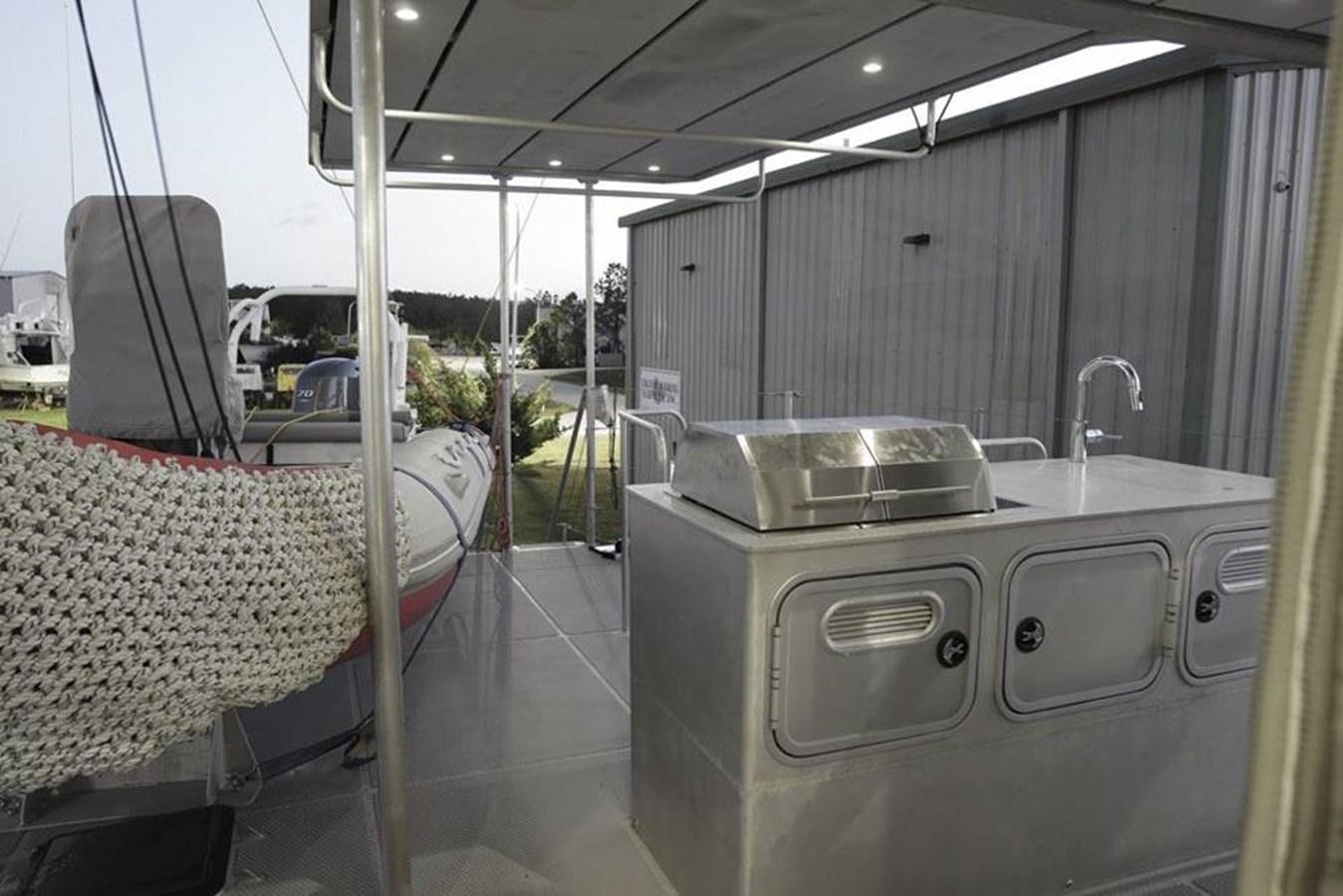 a room with a sink and a bed aboard IRON LADY II Yacht for Sale