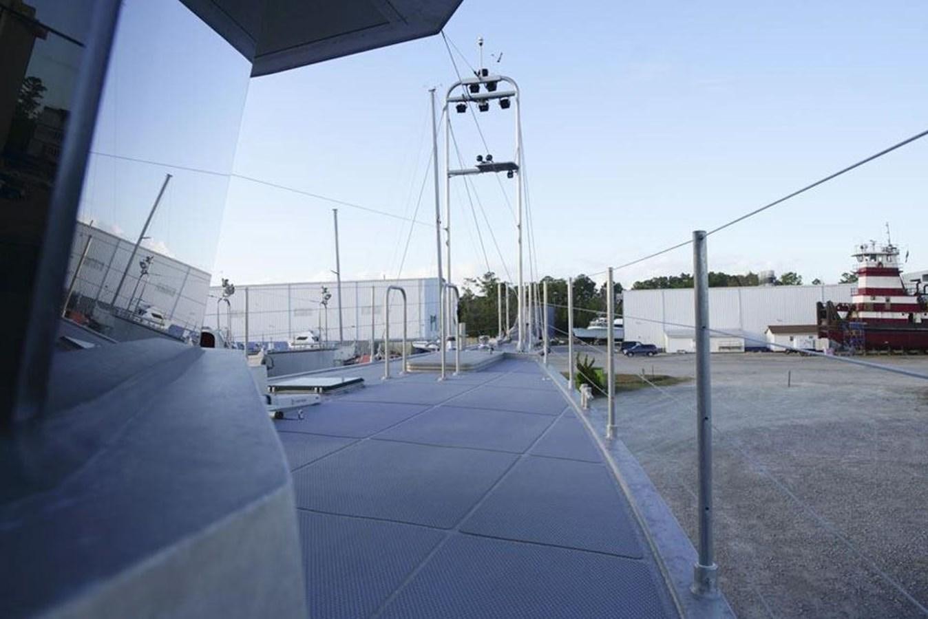 a deck with a large tower and a building in the background aboard IRON LADY II Yacht for Sale