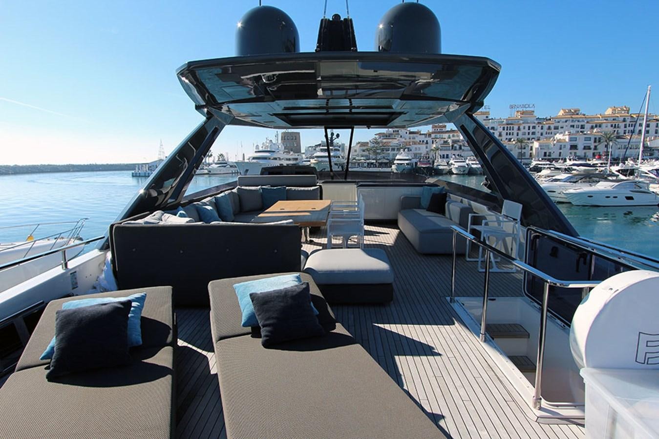 a deck with a large boat on it and a large building in the background aboard ANASSA A Yacht for Sale