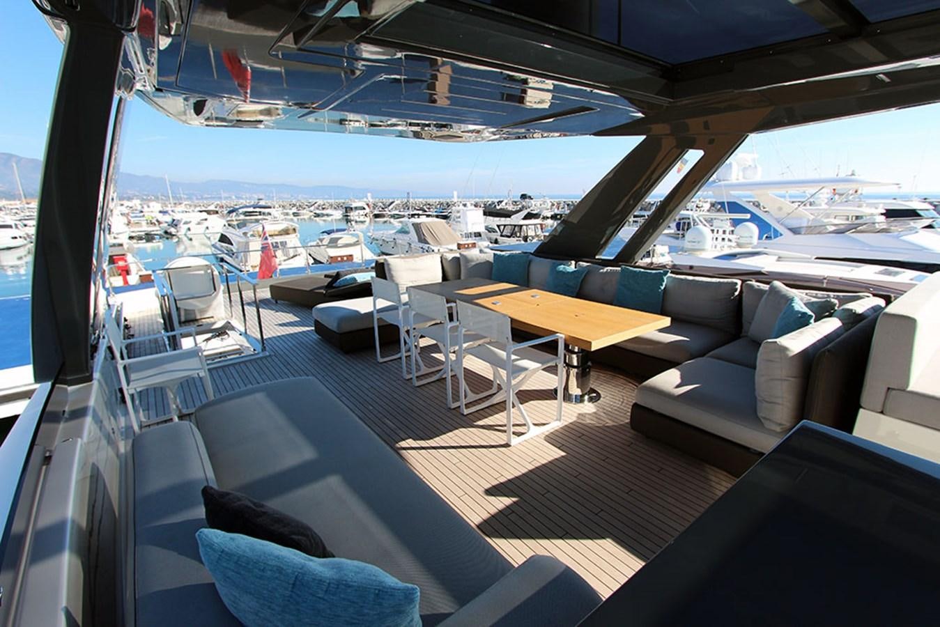 a boat deck with chairs and tables aboard ANASSA A Yacht for Sale