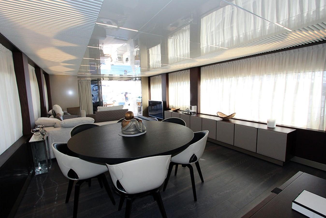 a large room with a table and chairs aboard ANASSA A Yacht for Sale