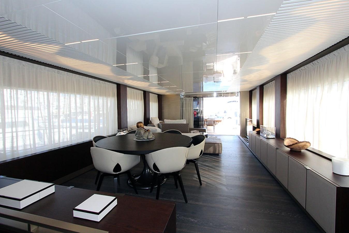 a large room with a table and chairs aboard ANASSA A Yacht for Sale