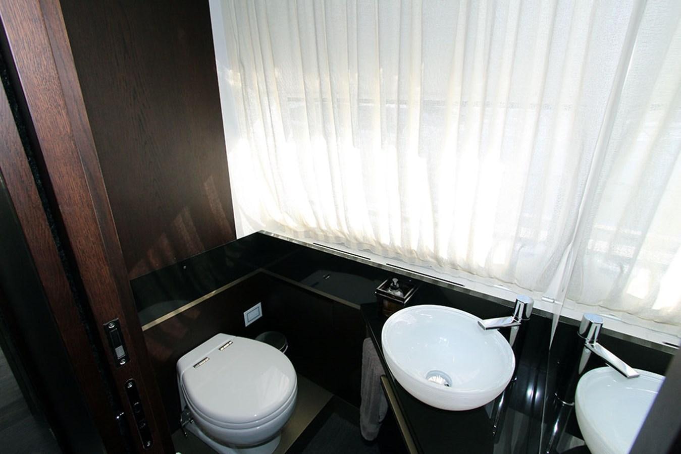 a bathroom with a tub sink and toilet aboard ANASSA A Yacht for Sale