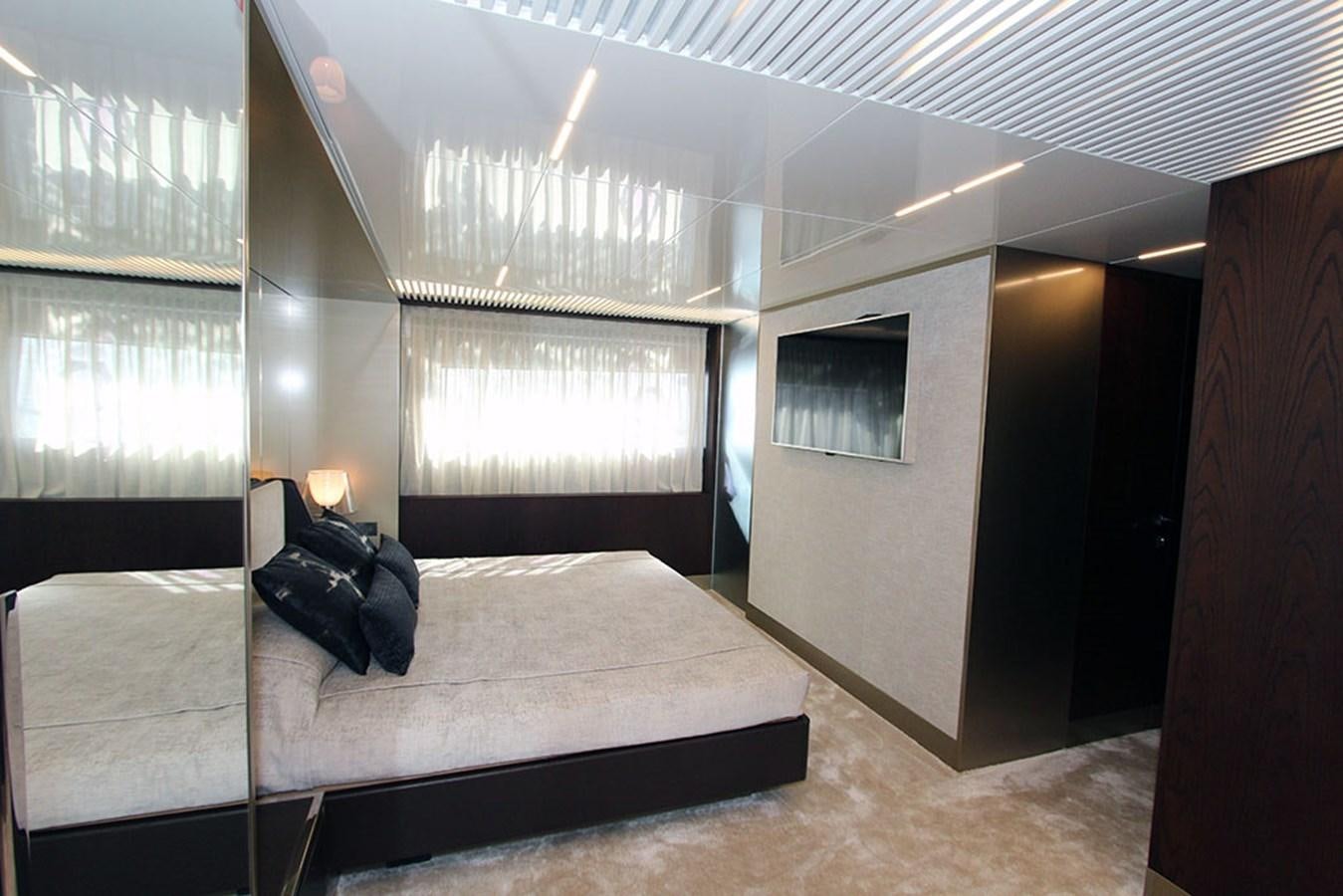 a room with a bed and a window aboard ANASSA A Yacht for Sale