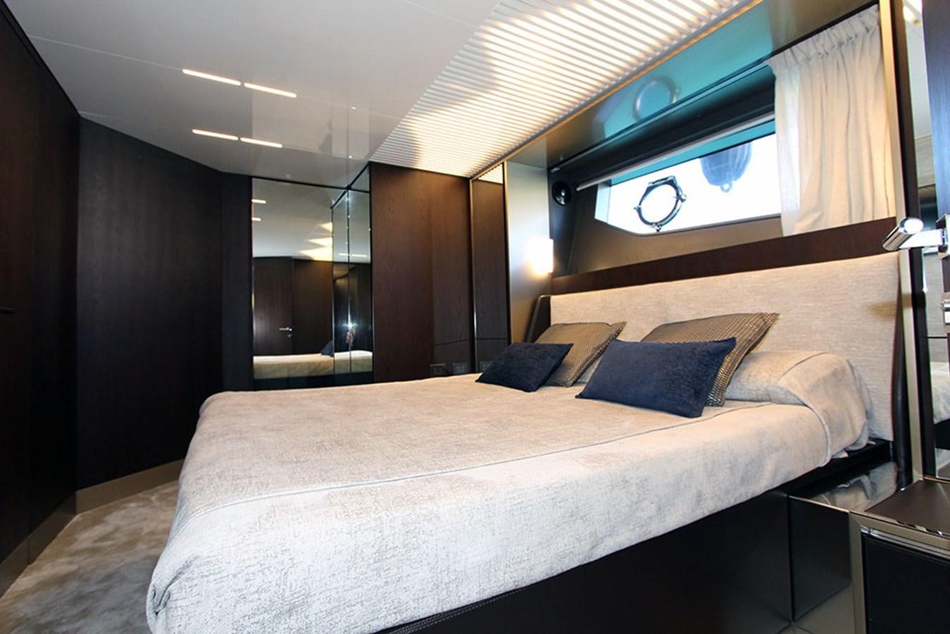a bed with a white bed spread aboard ANASSA A Yacht for Sale