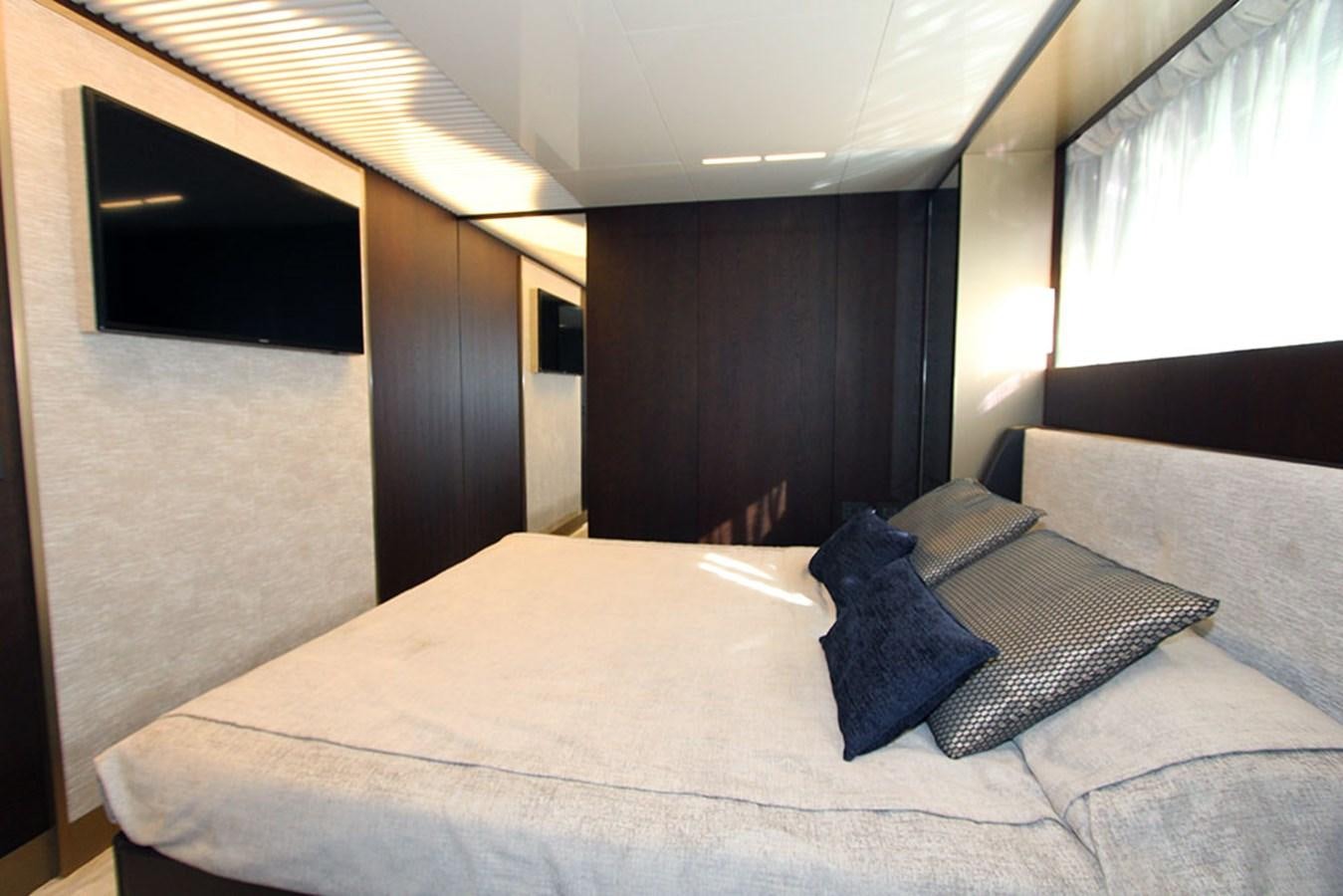 a bed with a white sheet and pillows aboard ANASSA A Yacht for Sale