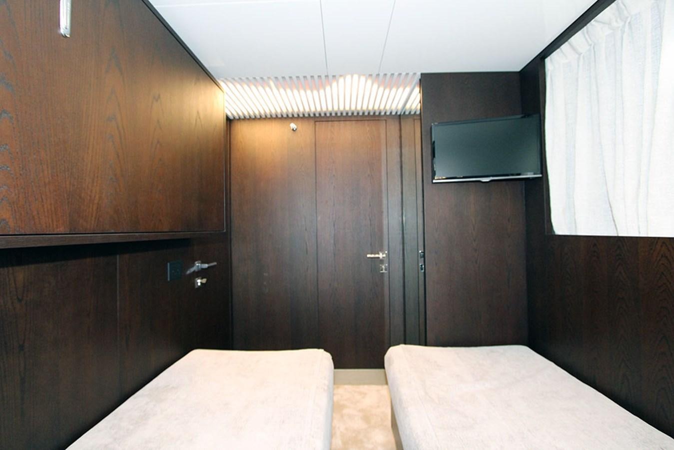 a room with a bed and a desk aboard ANASSA A Yacht for Sale