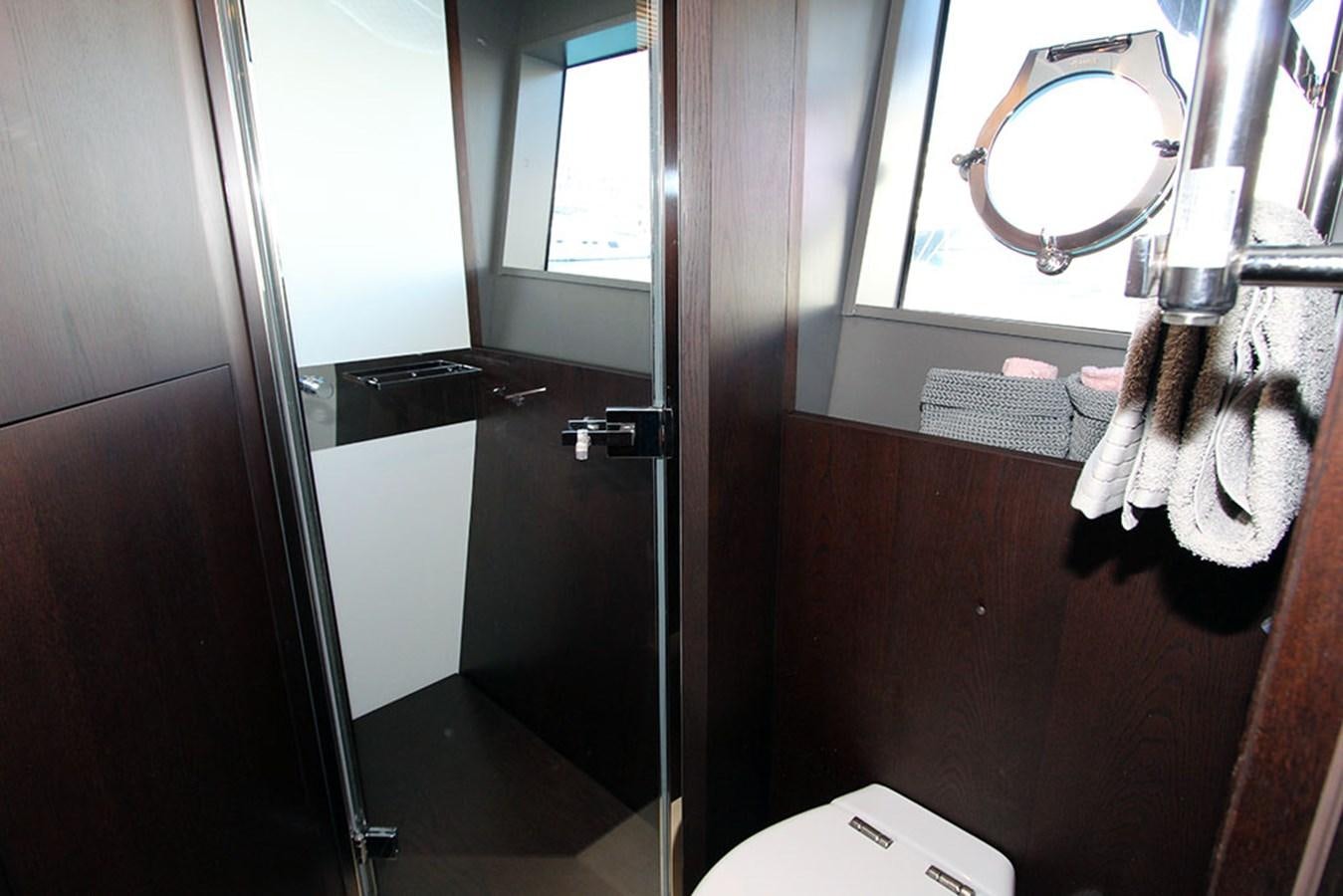 a bathroom with a mirror and a sink aboard ANASSA A Yacht for Sale