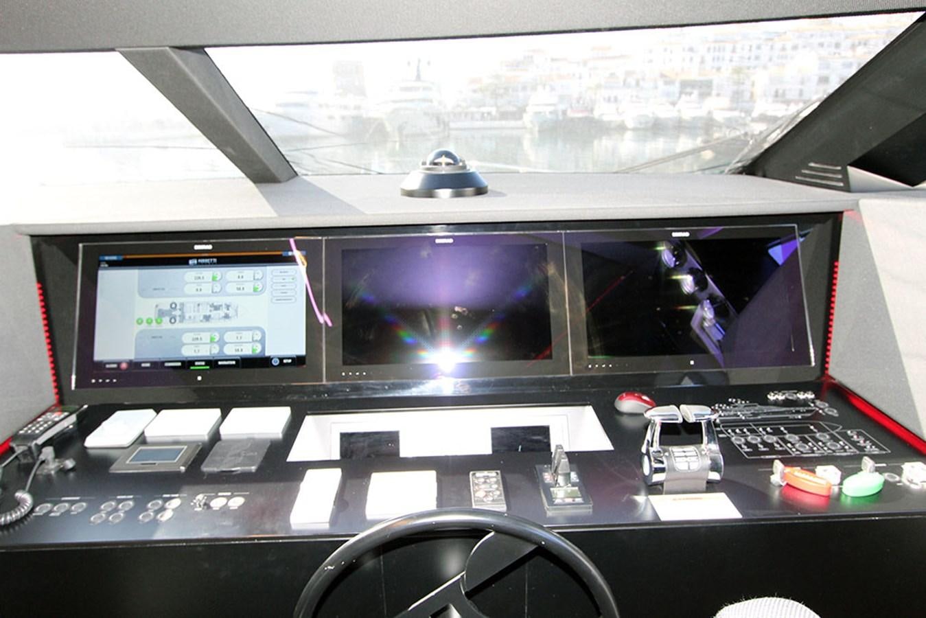 a computer set up with a couple of monitors and a black chair aboard ANASSA A Yacht for Sale