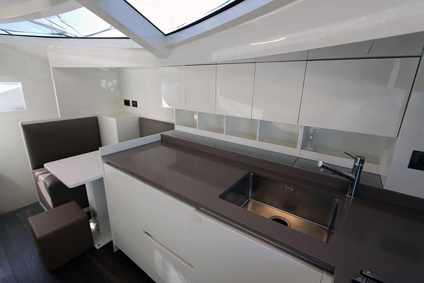 a kitchen with a large island aboard ANASSA A Yacht for Sale