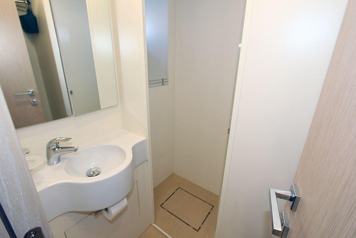 a bathroom with a sink and mirror aboard ANASSA A Yacht for Sale
