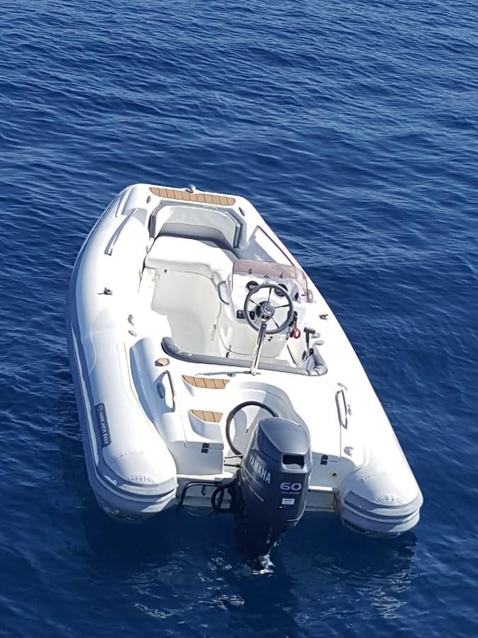 a white and black car on water aboard BARON B Yacht for Sale