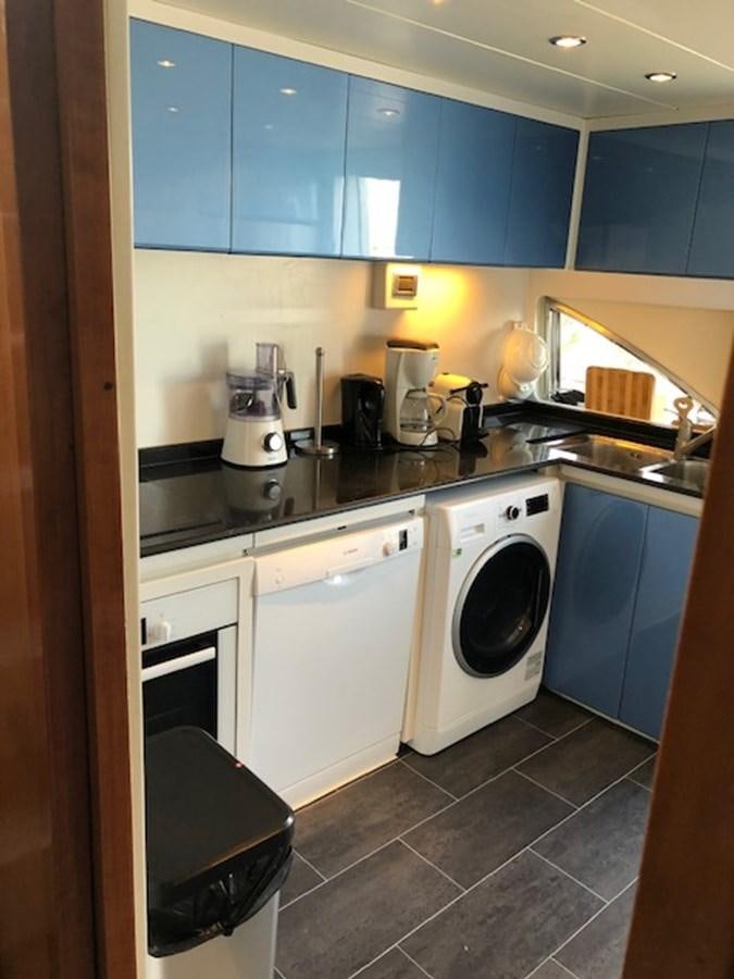 a washing machine in a kitchen aboard BARON B Yacht for Sale