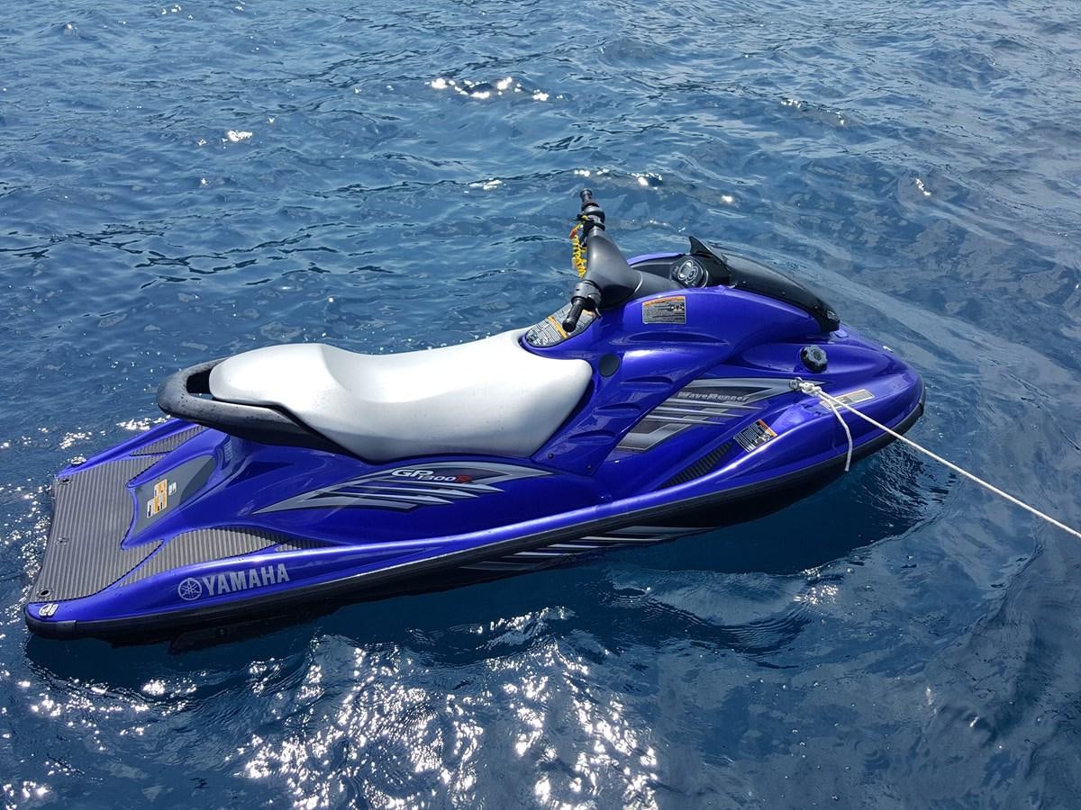 a blue and purple kayak on water aboard BARON B Yacht for Sale