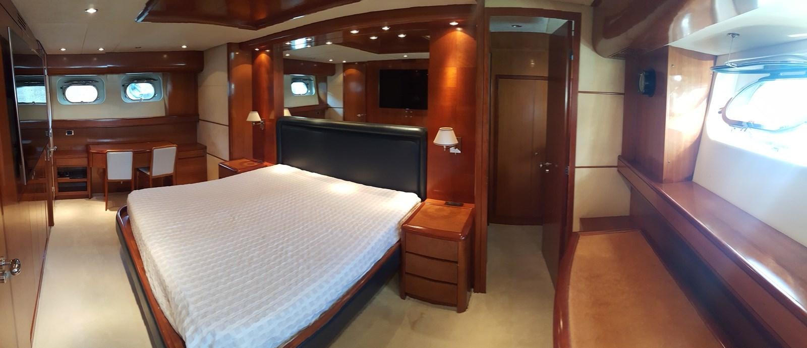 a room with a bed and a tv aboard BARON B Yacht for Sale