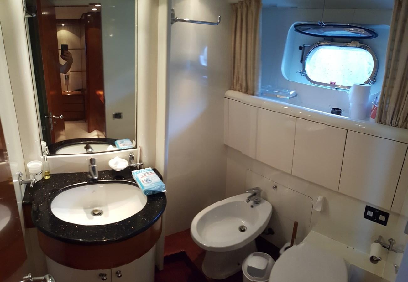 a bathroom with a sink and a large mirror aboard BARON B Yacht for Sale