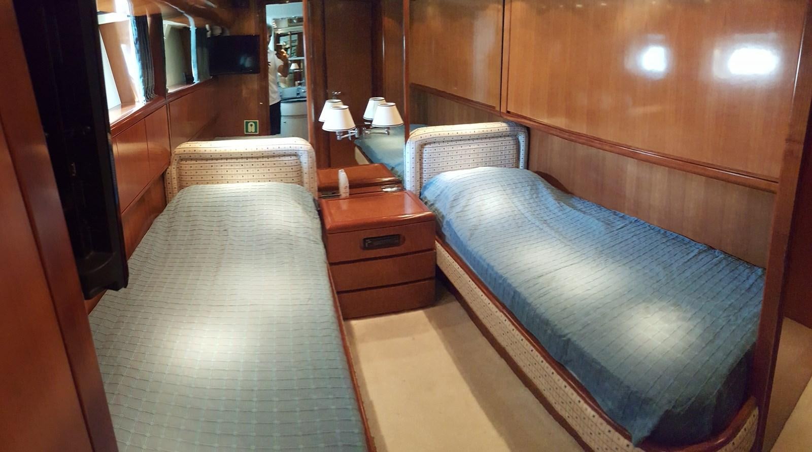 a room with a bed and a dresser aboard BARON B Yacht for Sale
