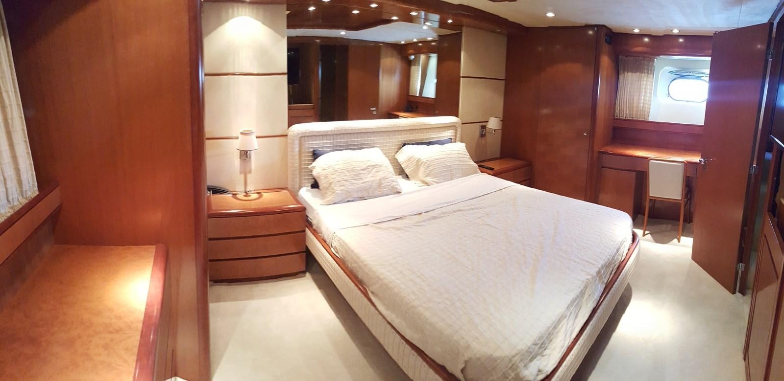 a room with a bed and a desk aboard BARON B Yacht for Sale