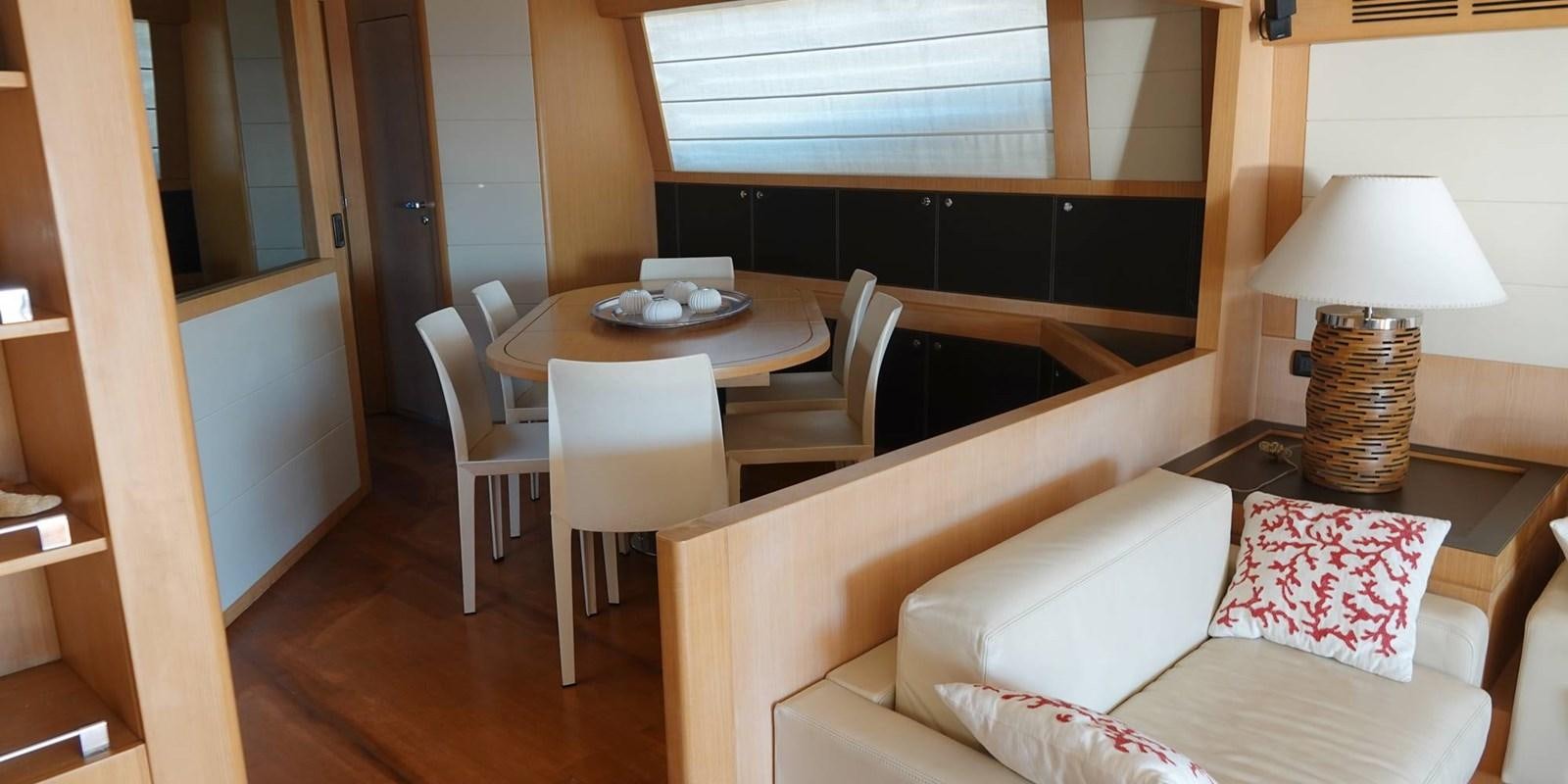 a room with a table and couch aboard 4 FIVE Yacht for Sale