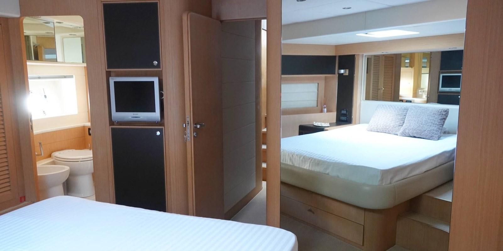 a room with a bed and a television aboard 4 FIVE Yacht for Sale