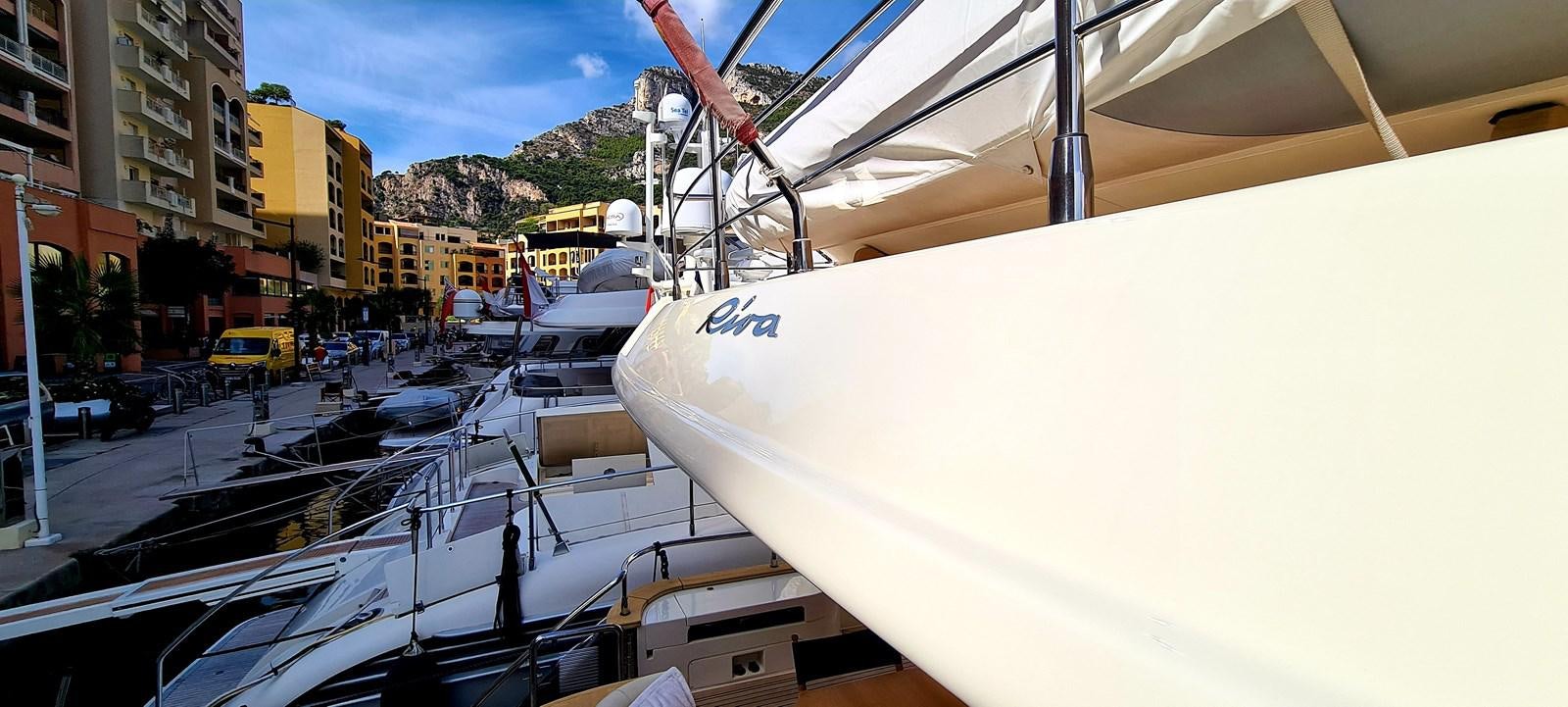a white boat in a harbor aboard RITAKI 7 Yacht for Sale