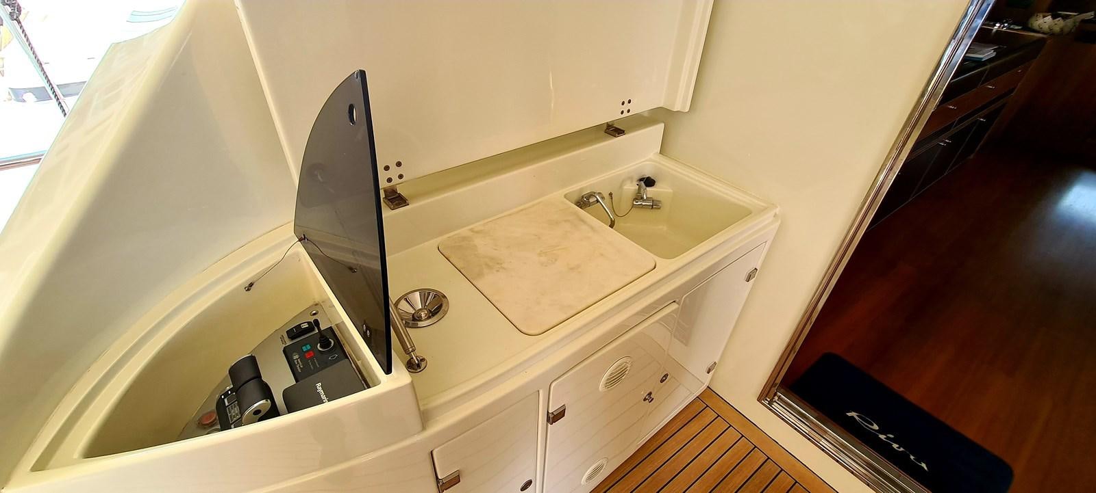 a kitchen with a sink and a large mirror aboard RITAKI 7 Yacht for Sale