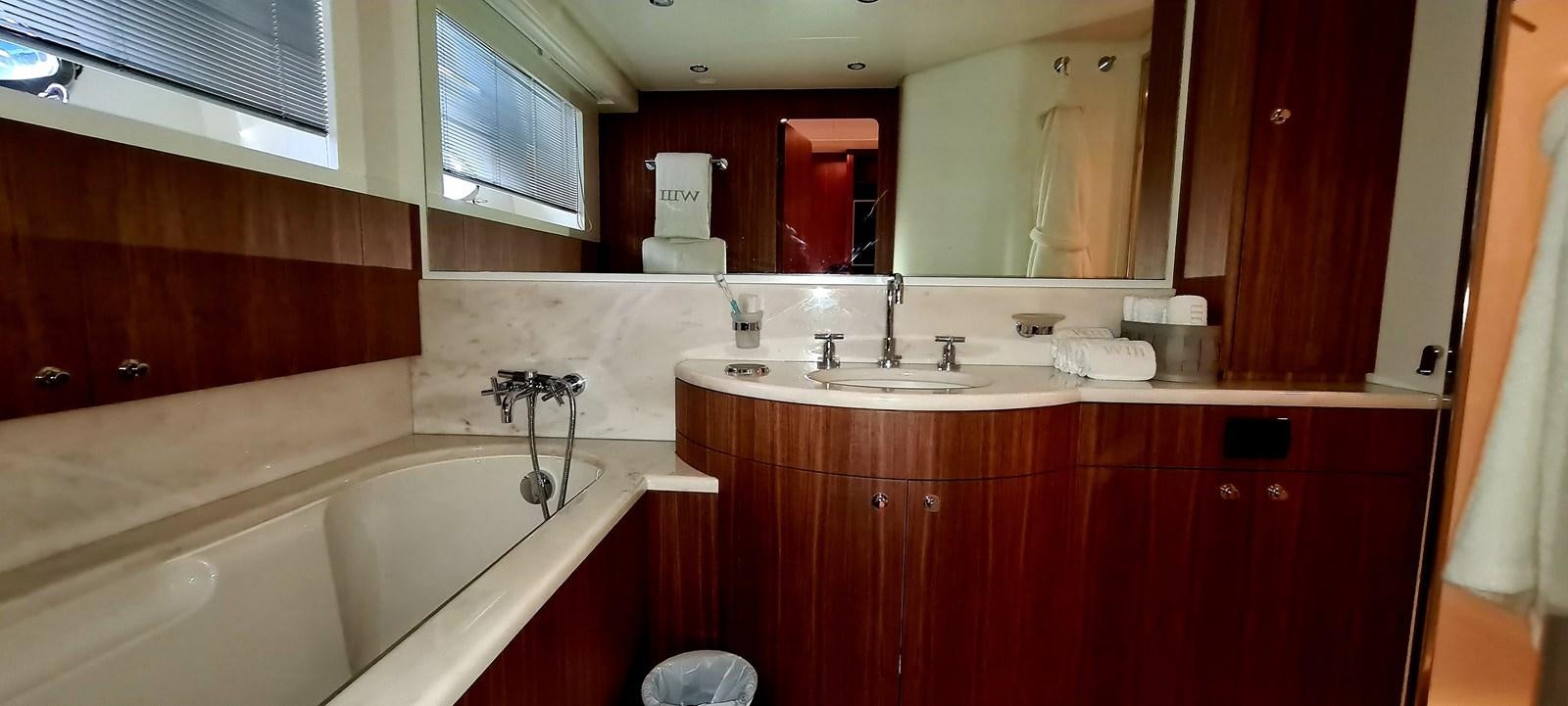 a bathroom with a tub sink and a sink aboard RITAKI 7 Yacht for Sale