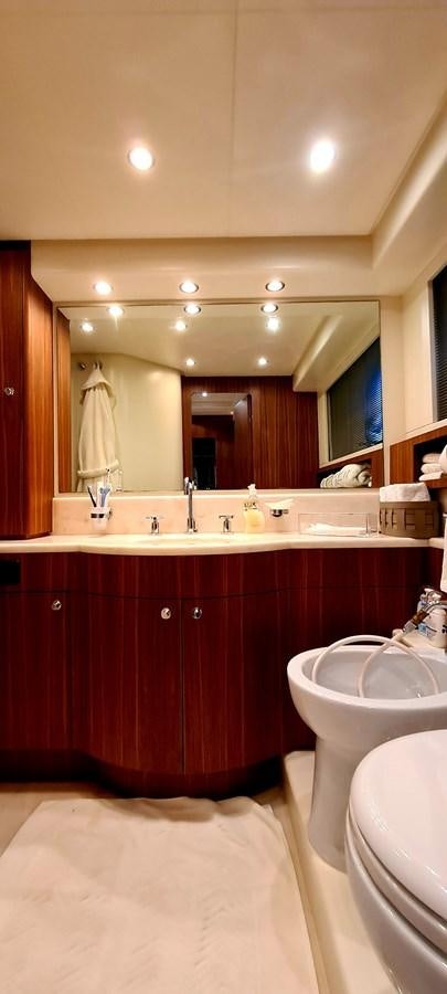 a bathroom with a large mirror aboard RITAKI 7 Yacht for Sale