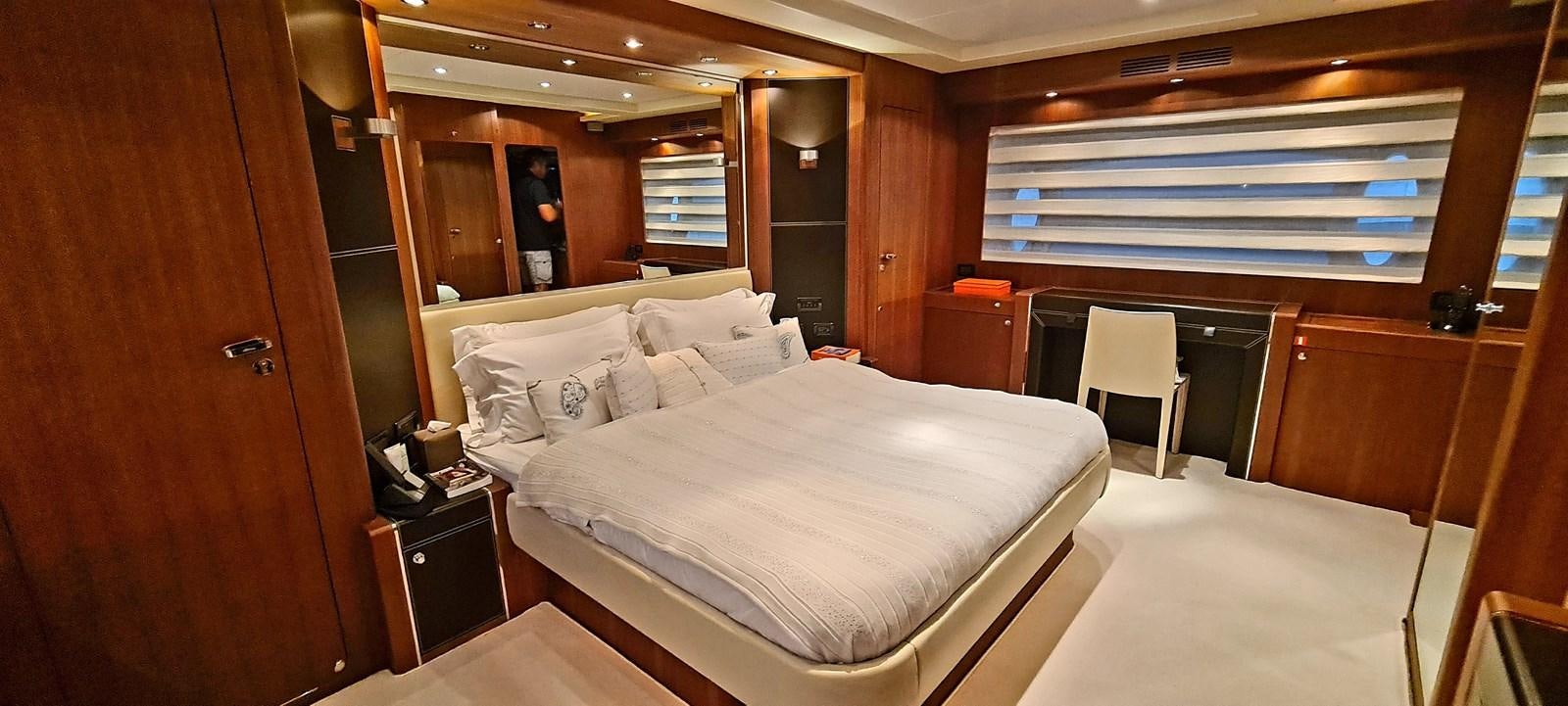 a room with a bed and a chair aboard RITAKI 7 Yacht for Sale